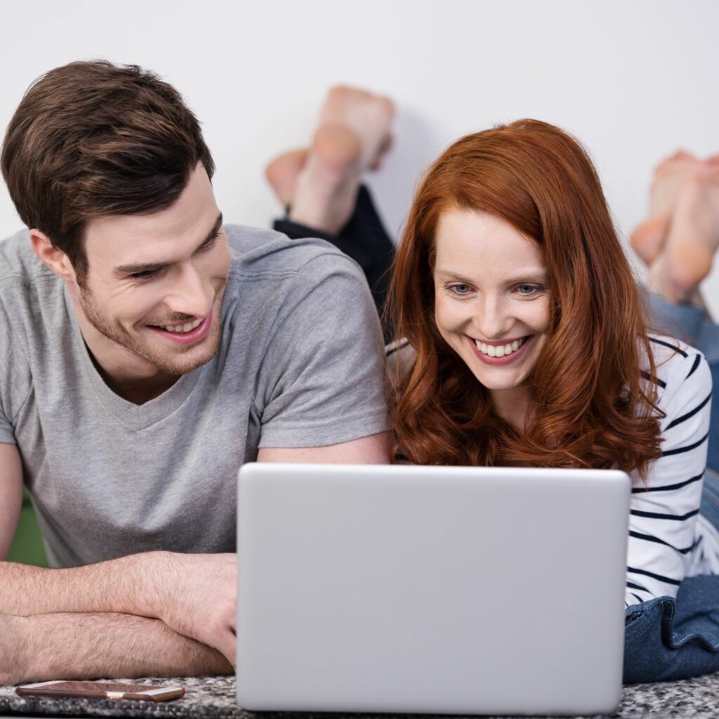 couple on computer | Carpet Outlet Plus