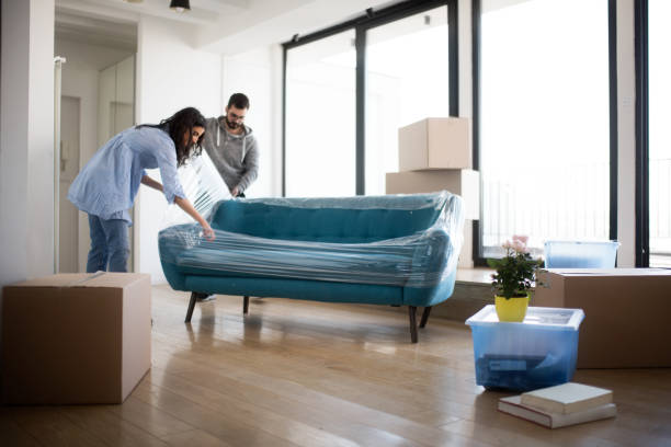 Couple moving sofa | Carpet Outlet Plus